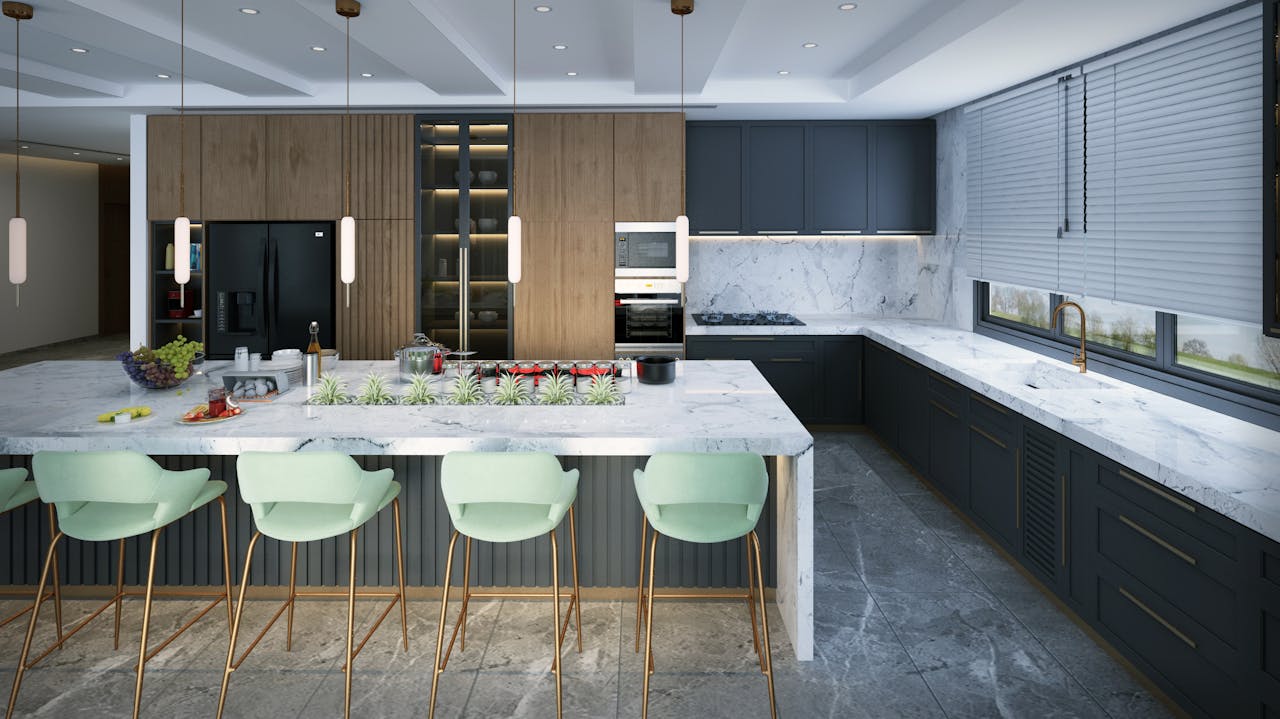 Spacious modern kitchen featuring marble countertops, mint green bar stools, and elegant pendant lighting.